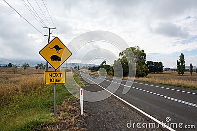â€˜Kangaroo and Wombat Crossing. 10kmâ€™ sign in Australia Stock Photo